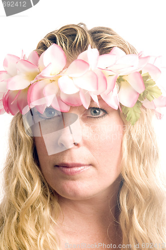 Image of pretty middle age woman wearing hawaiian floral lei in her hair