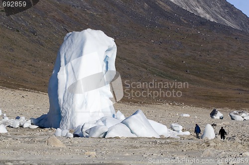 Image of Tourist in front of iceberg