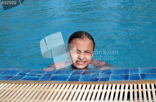 Image of Beautiful girl in pool with blue water