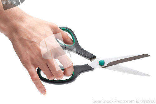 Image of Feminine hand with scissors