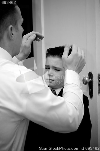 Image of Father Helping Son Get Ready