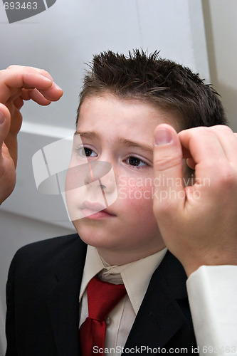Image of Father Helping Son Get Ready
