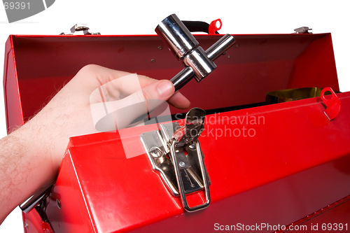 Image of Hand removing a wrench from a toolbox