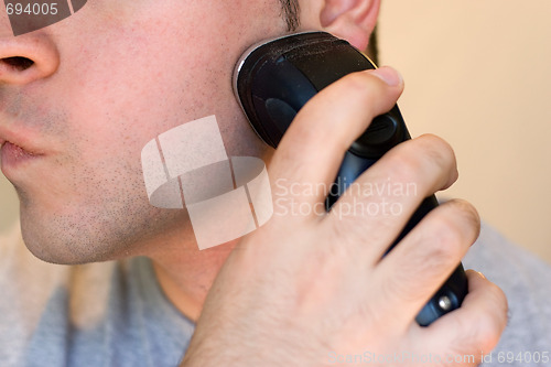 Image of Young Man Shaving