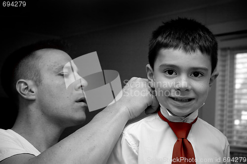 Image of Father Helping Son Get Ready