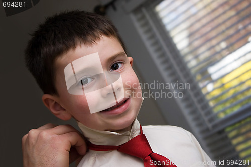 Image of Father Helping Son Get Ready