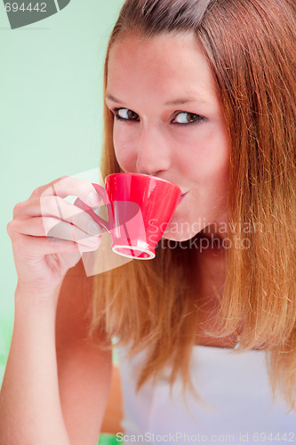 Image of Redhead woman drinking coffee