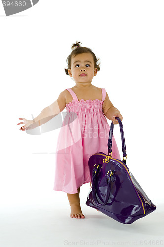 Image of little thai-english girl walking with purse