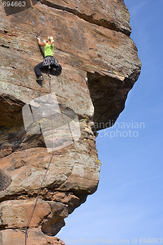 Image of Rock climbing woman