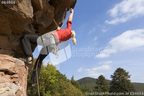 Image of Rock climbing woman