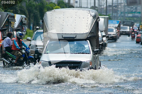 Image of Flooded street with trucks and cars