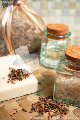 Image of Natural soap, bottles of essential oil and sea salt, dry lavende