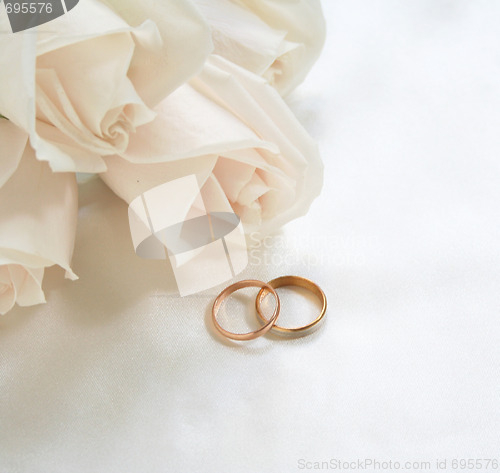 Image of Wedding rings and roses as background 