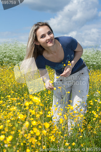 Image of Beautiful girl in field with yellow flower