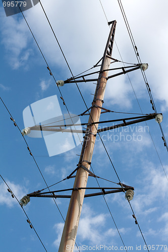 Image of Pole high-tension wire on background blue sky