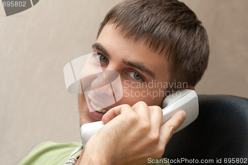 Image of Man with telephone smiles