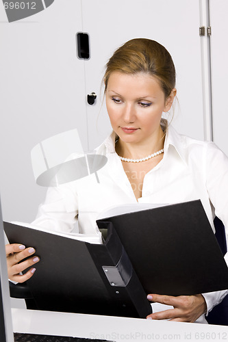Image of beautiful young woman working with documents