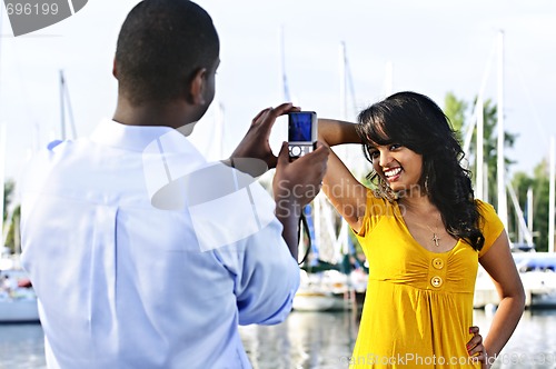 Image of Woman posing for picture near boats