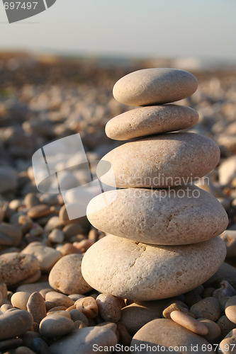 Image of Pyramid of water rounded stones on the sea beach 