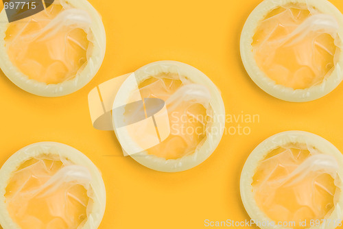 Image of condoms on orange background