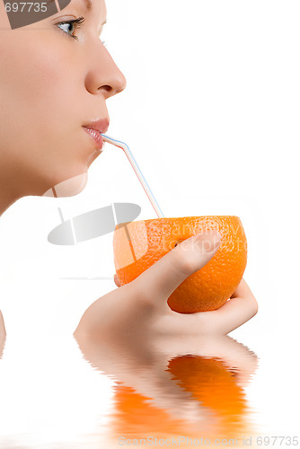 Image of Pretty girl drink orange juice on white