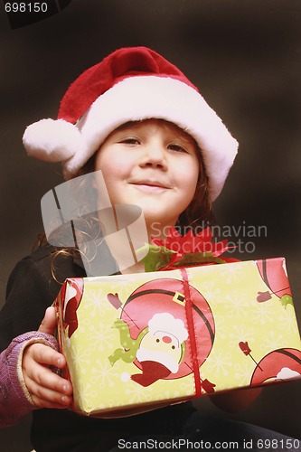 Image of Pretty young girl in Santa hat