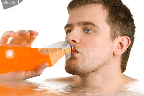 Image of Young man drinking orange juice