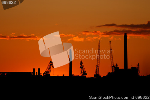 Image of  Silhouette of sea port cranes in the evening  