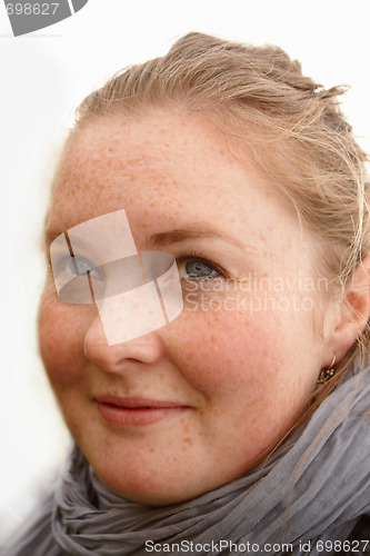 Image of Cute friendly young woman looking at you