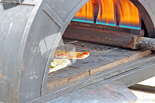 Image of Preparing a tasty pizza in the oven