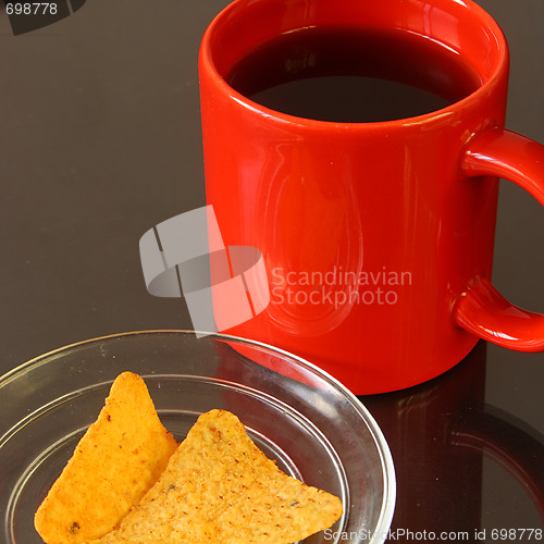 Image of Red mug and chips on glass plate