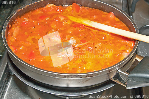 Image of Healthy cooking. The pot with fresh vegetables in the tomato sau