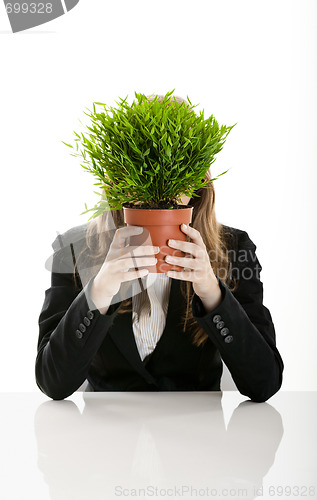 Image of Business Woman holding a vase with a plant
