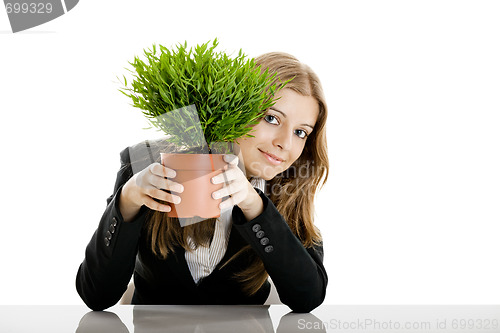 Image of Business Woman holding a vase with a plant