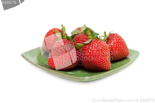 Image of Strawberries on green chinese saucer