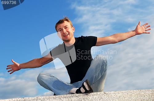 Image of young happy welcoming man