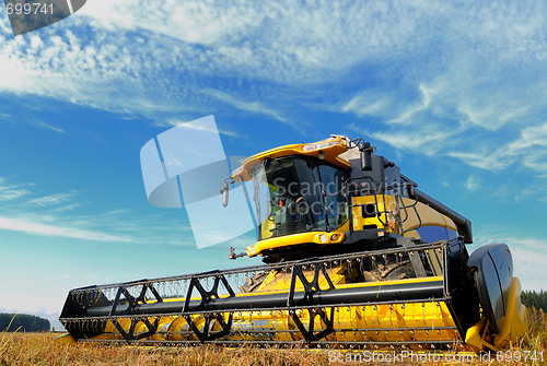 Image of harvesting combine in the field