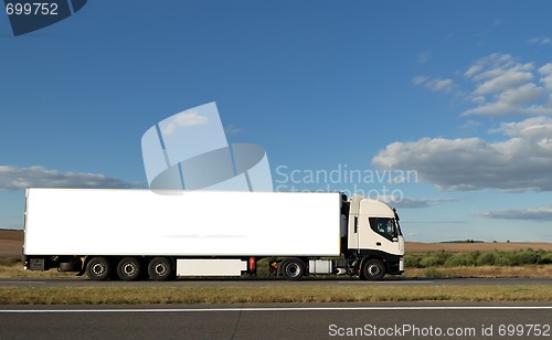 Image of Long white truck on highway