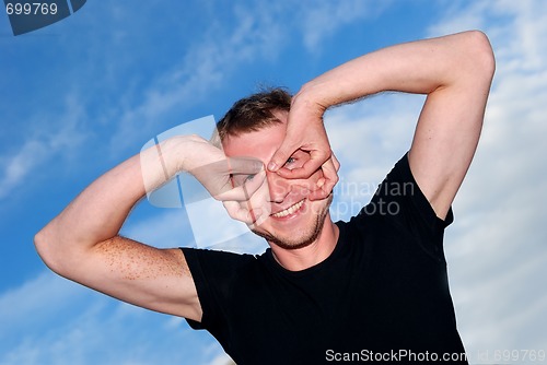 Image of funny young man outdoors