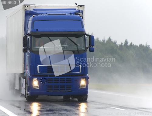 Image of Blue Lorry on wet road