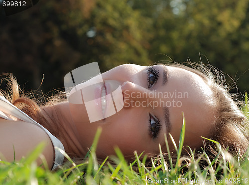 Image of Beautiful young girl outdoors in summer