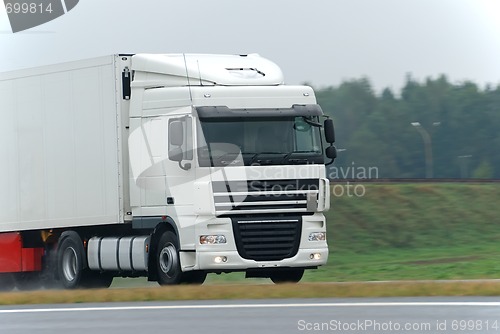 Image of White lorry on wet road