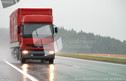 Image of Red lorry on wet road