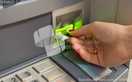 Image of Inserting plastic card visa into ATM