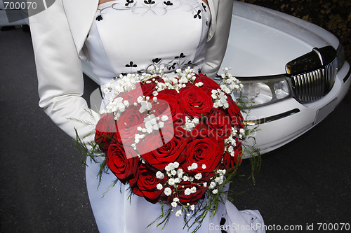 Image of Bride standing front of  a limosine