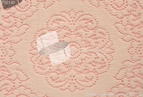 Image of soft lace doily on pink