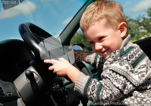 Image of smiling boy and steering wheel