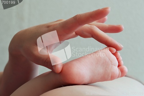 Image of hand and child foot