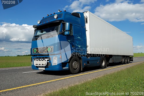 Image of blue lorry with white trailer 