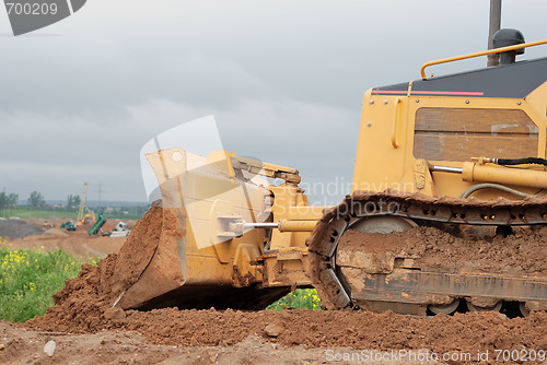 Image of small bulldozer blade in action